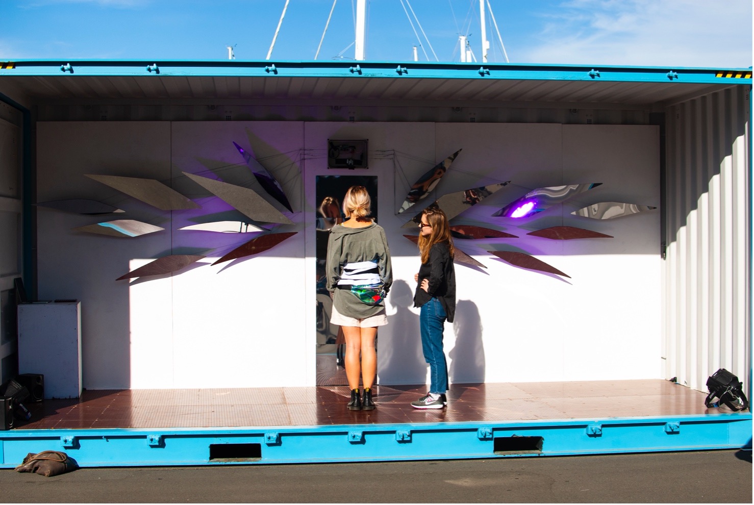 Babyface by Kate Ladenheim x The RAD Lab. Presented at the Performance Arcade in Wellington, NZ in February 2020. Audience member participating in the breath-activated installation (left) being led through a calibration and onboarding procedure by Amy LaViers (right). Photo by Colin Edson.