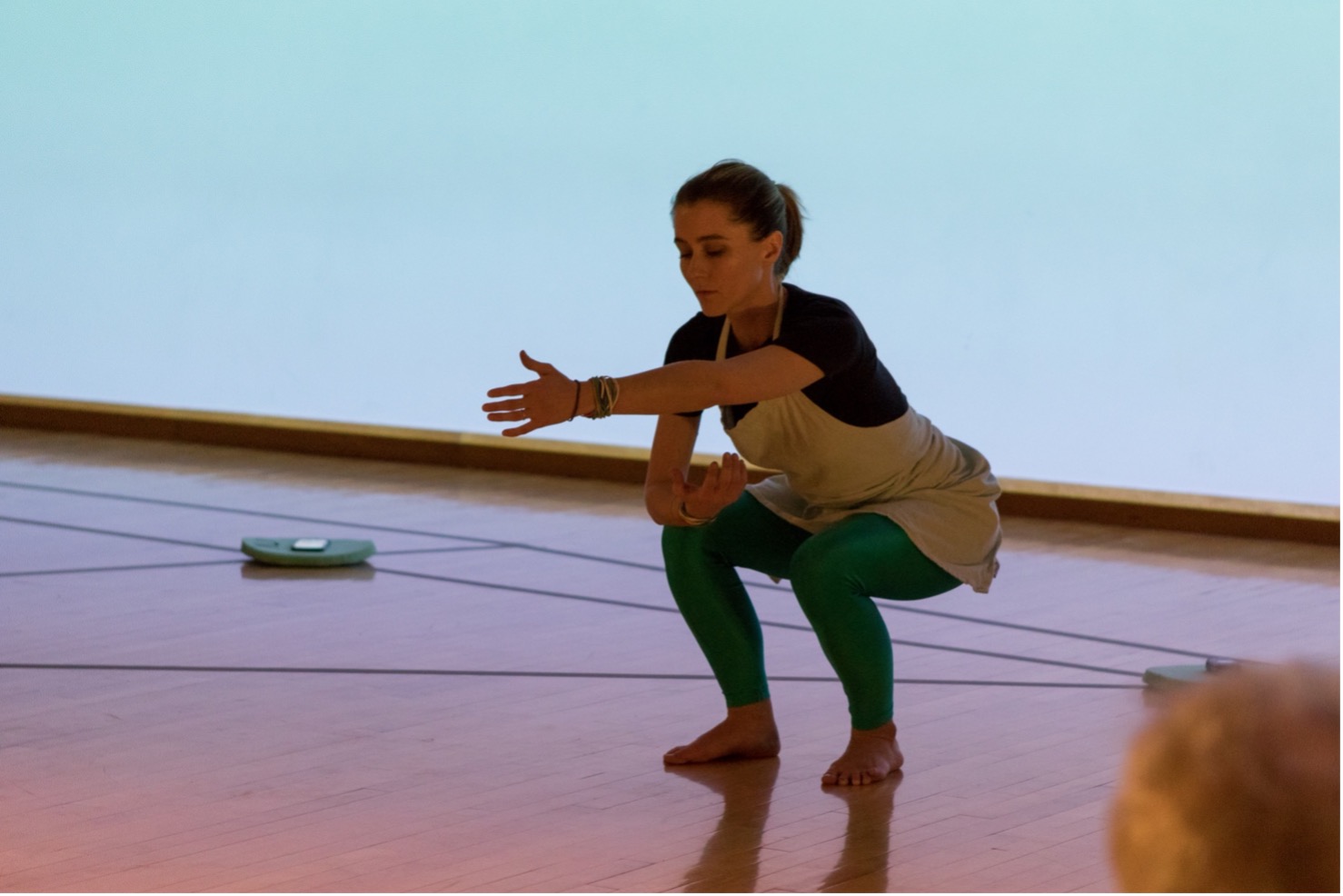 A Machine by The RAD Lab. Performed in DRK at the Krannert Center for Performing Arts in Urbana, IL in December 2018. Amy LaViers dancing with an audience member’s cell phone, used to create part of the soundscape for the piece, lying on a labeled cushion. Photo by Natalie Fiol.