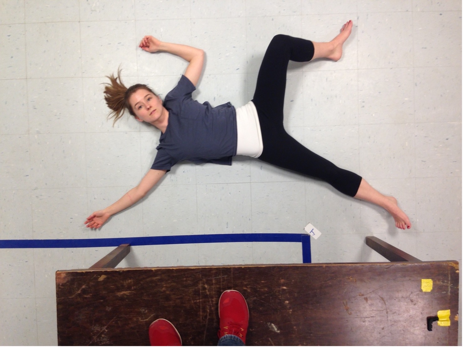 Photo for the draft of “Embodied movement strategies for development of a core-located actuation walker” for the 6th IEEE International Conference on Biomedical Robotics and Biomechatronics (BioRob 2016). Amy LaViers demonstrates a body half from Bartenieff Fundamentals. Photo by Jason Ye.