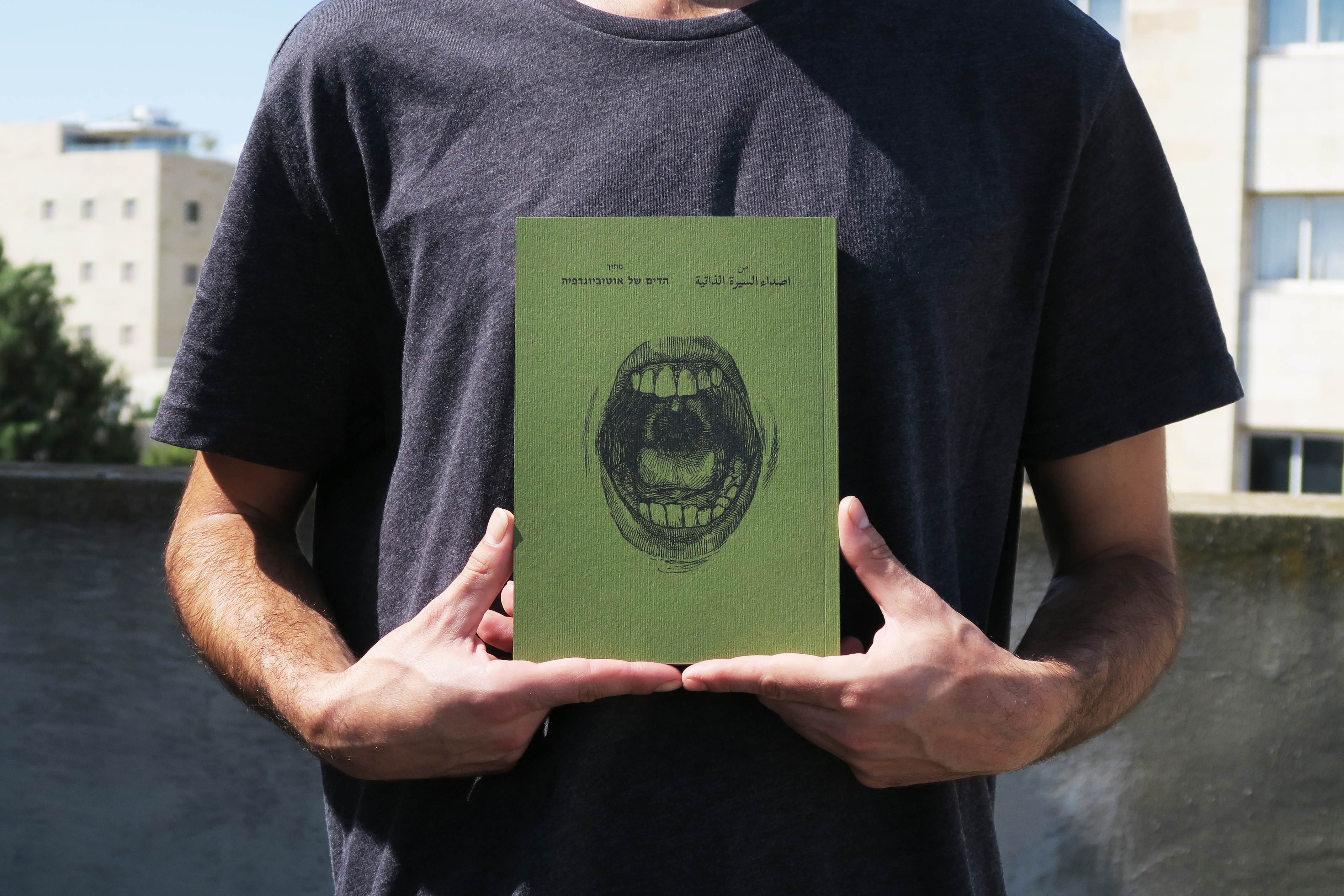 A man holding a book cover